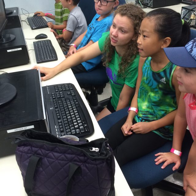 Image of summer camp participants coding