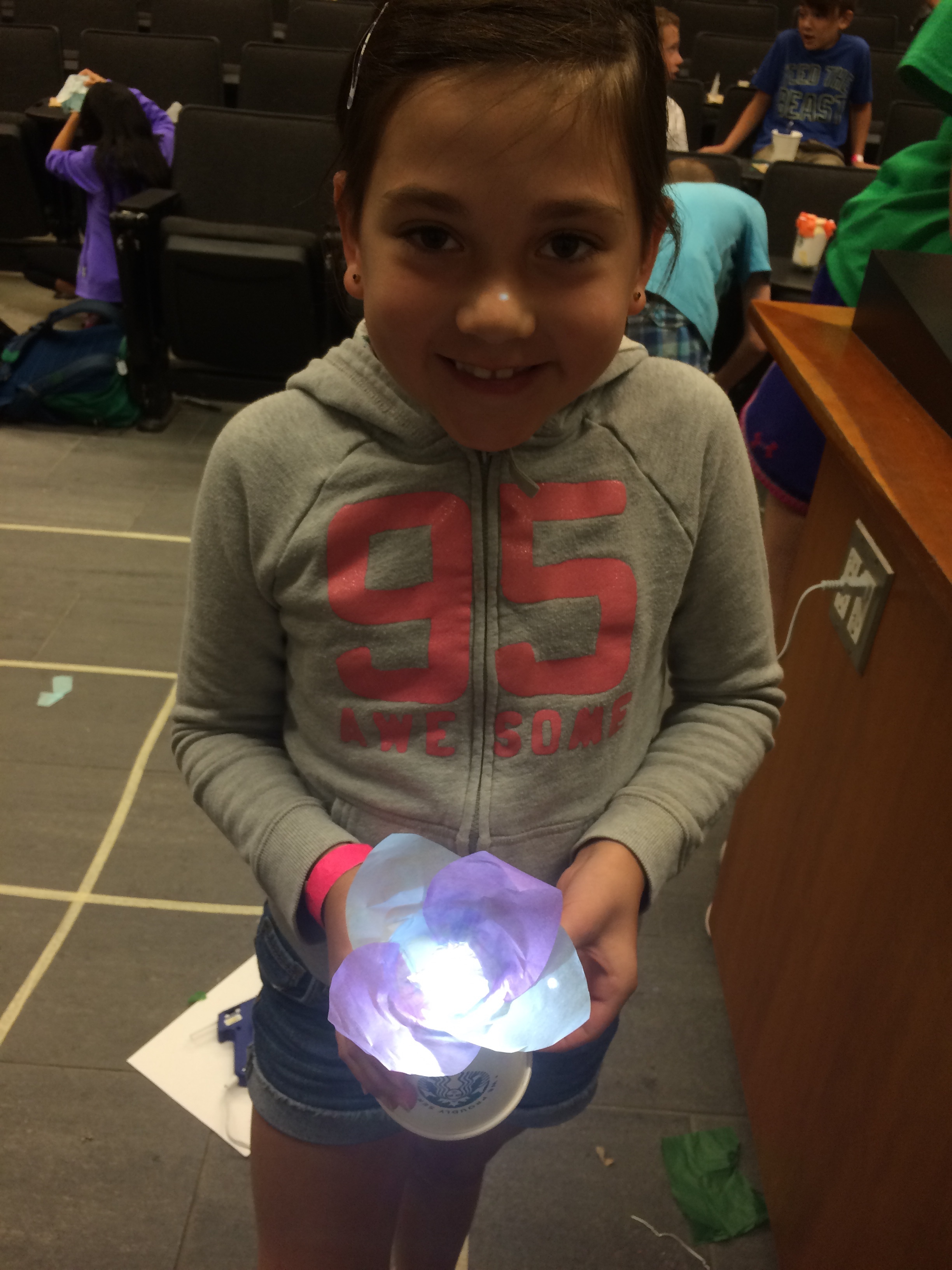 Summer camp participant with LED flower